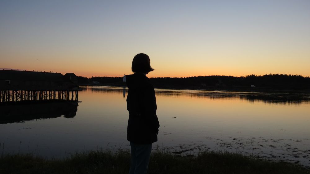 Stacy watching the sun rise over a pier at Lubec, Maine, 2013